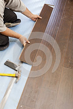 Man Installing New Laminate Wood Flooring