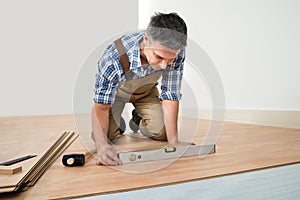 Man installing new laminated wooden floor