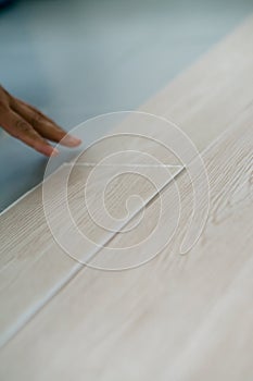 A man installing new vinyl tile floor, a DIY home project