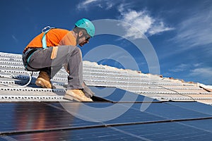 Man installing photovoltaic solar panels to produce green and clean energy