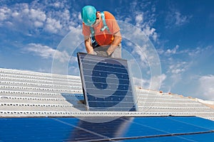 Man installing photovoltaic solar panels to produce green and clean energy