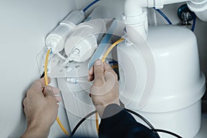 man installing a reverse osmosis system