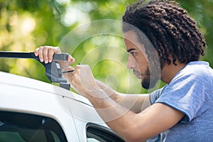 man installing roof rack photo