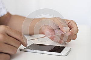 Man installing a screen protector in a smartphone