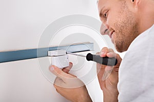 Man Installing Security System Door Sensor