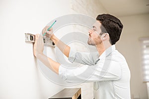 Man installing a shelf at home