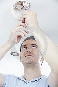 Man Installing Smoke Or Carbon Monoxide Detector