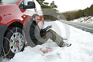 Man installing snow chains