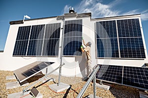 Man installing solar panels on a rooftop