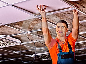 Man installing suspended ceiling