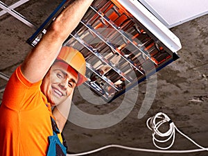 Man installing suspended ceiling