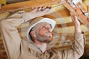 Man installing thermal roof insulation layer