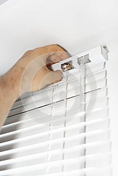 Man installing venetian blinds.