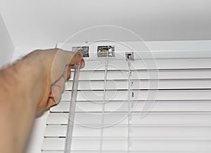 Man installing venetian blinds.