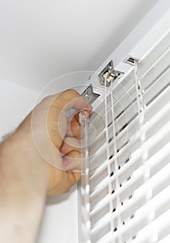 Man installing venetian blinds.