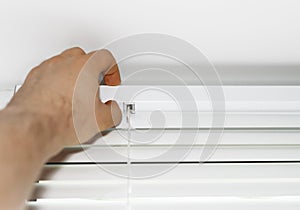 Man installing venetian blinds.