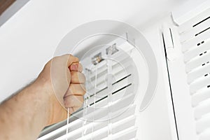 Man installing venetian blinds.