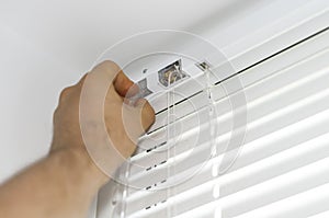 Man installing venetian blinds.