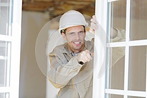 man installing window