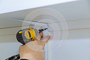 Man installing wooden shelves on brackets wall installing a shelf