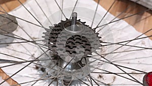 A man installs a ratchet on the rear wheel of a mountain bike. With a puller. Do-it-yourself mountain bike repair at home. Close-