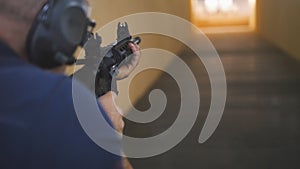 Man instructor have shooting with a Machinegun at the shooting gallery
