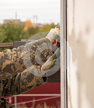 The man insulates the house with foam blocks