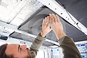 Man insulating the roof of his camper van