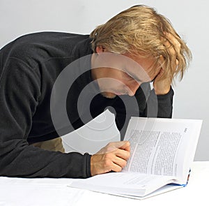 Man intently reading a book photo