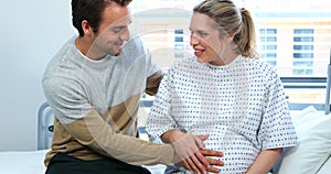 Man interacting with pregnant woman in ward