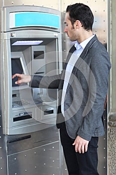 Man introducing PIN at ATM