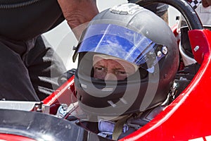 Man in IRL race car with helmet