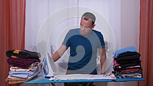 Man ironing with dopey confused shocked look.