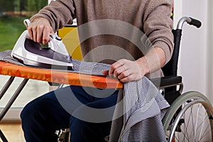 Man ironing his shirt