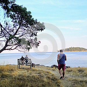 Man on an island by the shore thinking and contemplating