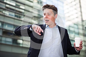 Man in jacket with documents hurrying to meeting