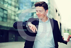 Man in jacket with documents hurrying to meeting