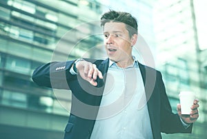 Man in jacket with documents hurrying to meeting