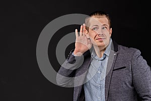 A man in a jacket hears important information on a black background