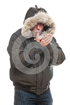 Man in jacket warming oneself