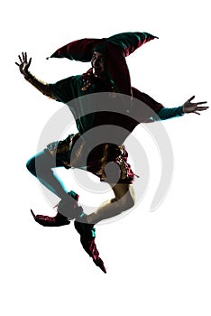 Man in jester costume silhouette jumping