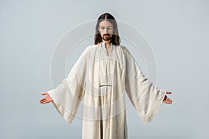 Man in jesus robe standing with outstretched hands photo