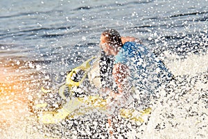Man on a jet ski in the spray of waves blurred image, letl, sea, water entertainment, summer