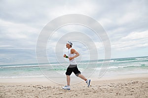 Man is jogging on the beach summertime sport fitness