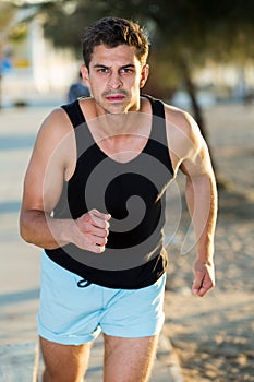 Man jogging on city seafront