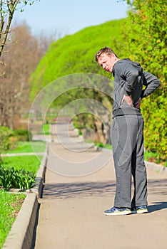 Man while jogging have begun back pain photo