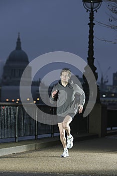 Man Jogging On Pavement At Night