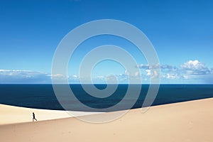 Man jogging on a sandy beach of Carlo Sandblow Rainbow in Australia