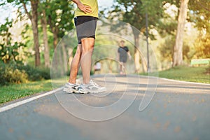 man jogging and walking on the road at morning, adult male in sport shoes running in the park outside. Exercise, wellness, healthy
