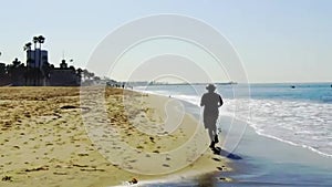 Man jogs on a Southern California beach